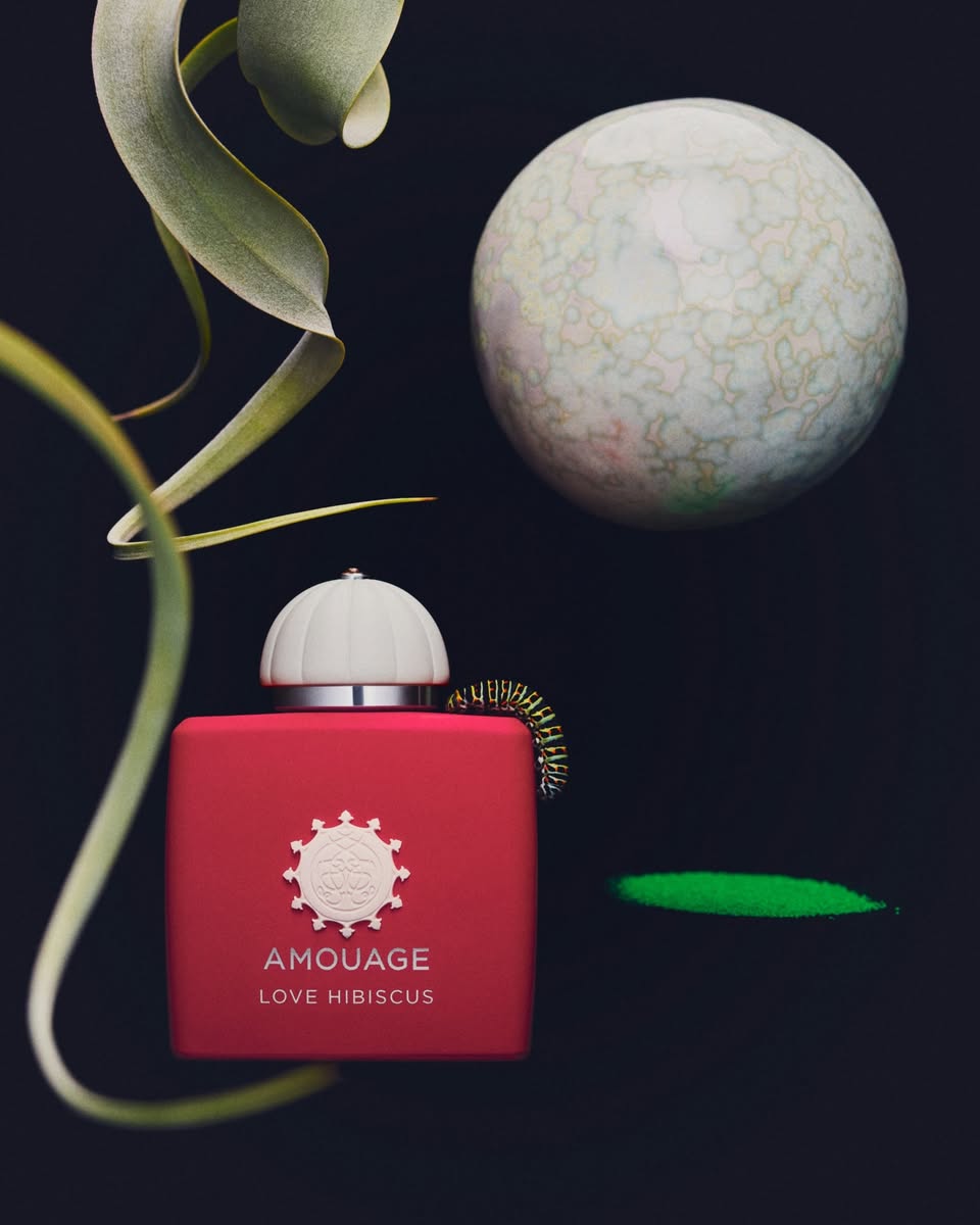 Amouage Love Hibiscus bottle with white cap and green ribbon accent