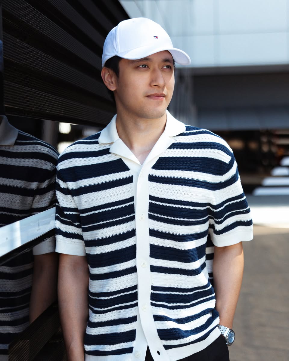 Zhou Guanyu wearing Tommy Hilfiger navy and white striped cardigan with cap