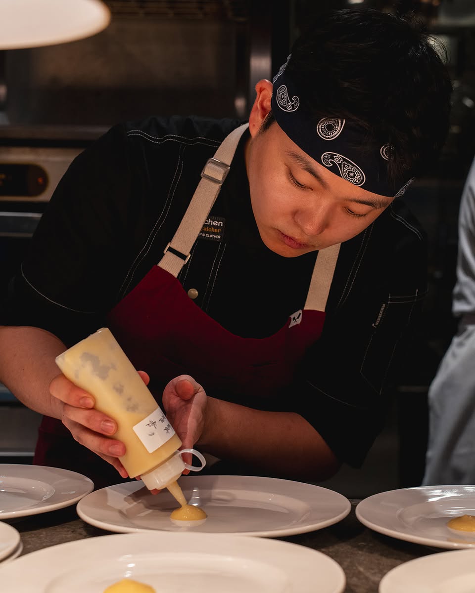Close-up of a chef meticulously preparing a gourmet course